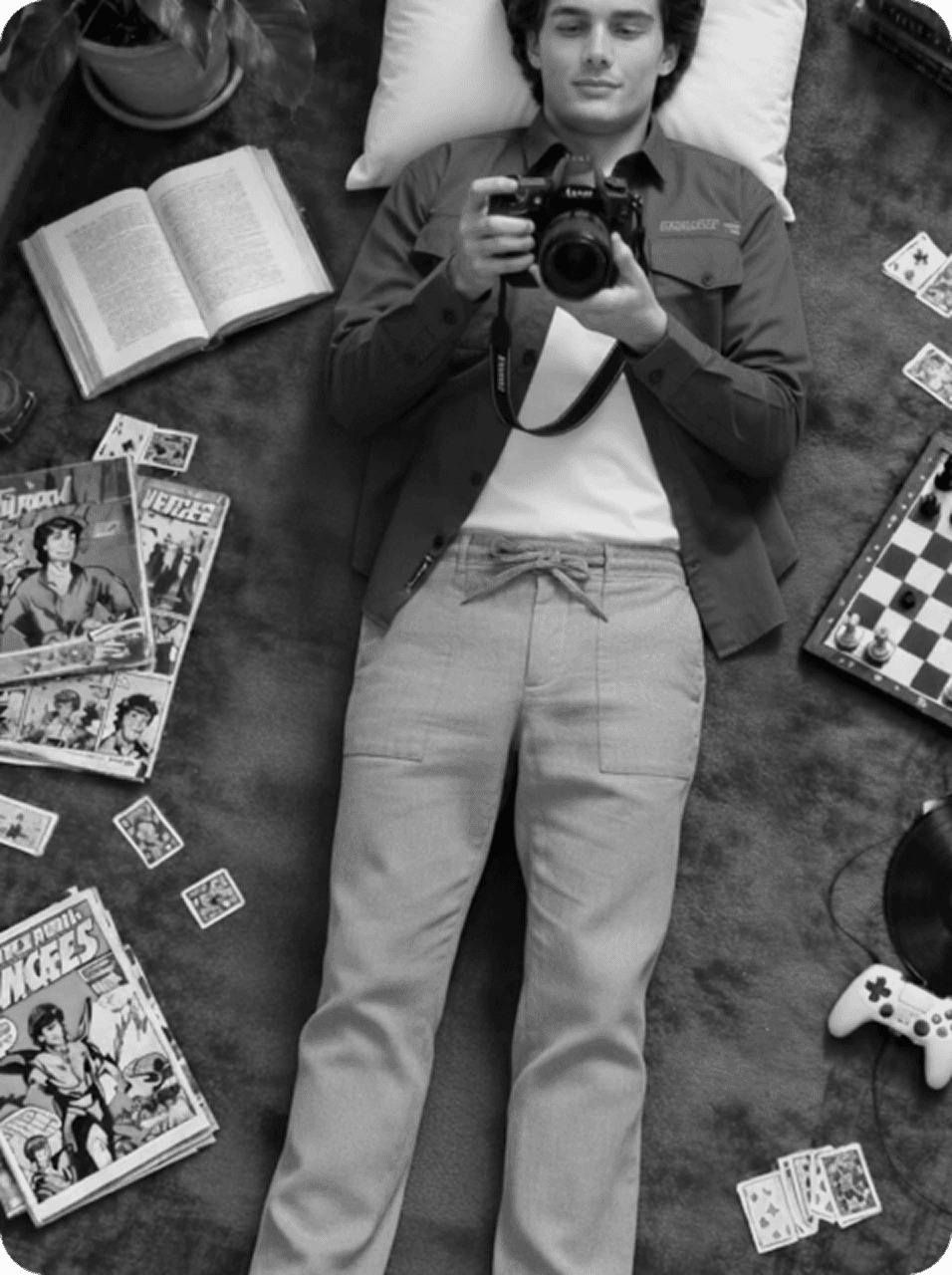 Black and white campaign visual of a model holding a camera