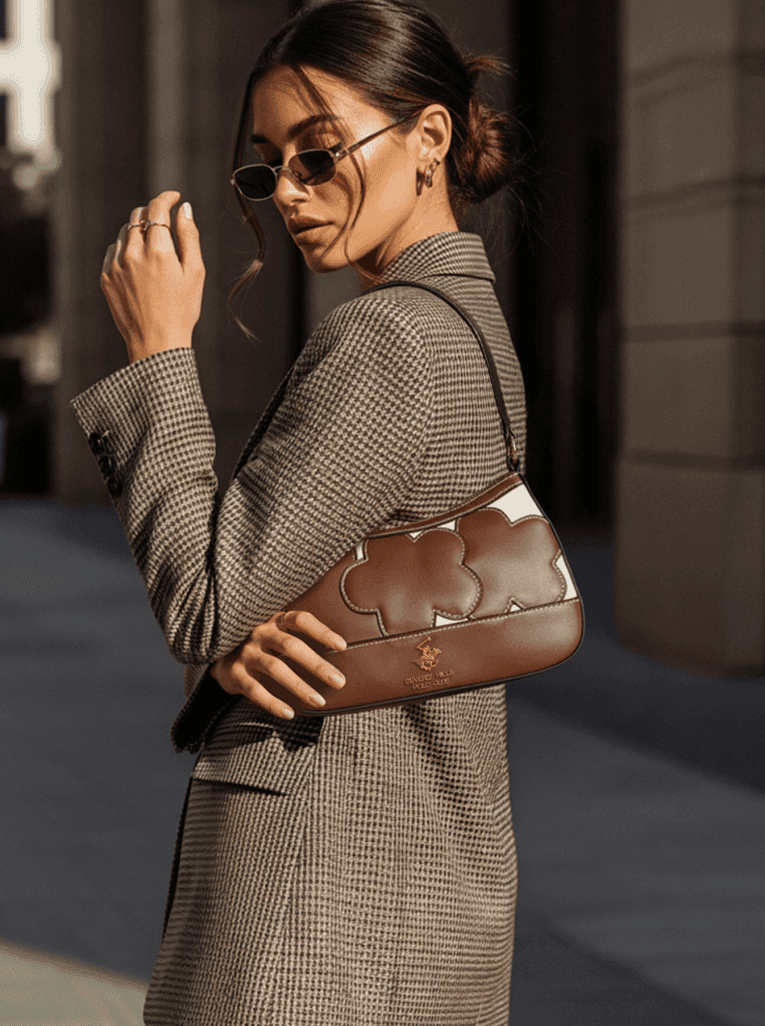 Model in sunglasses and blazer carrying the handbag