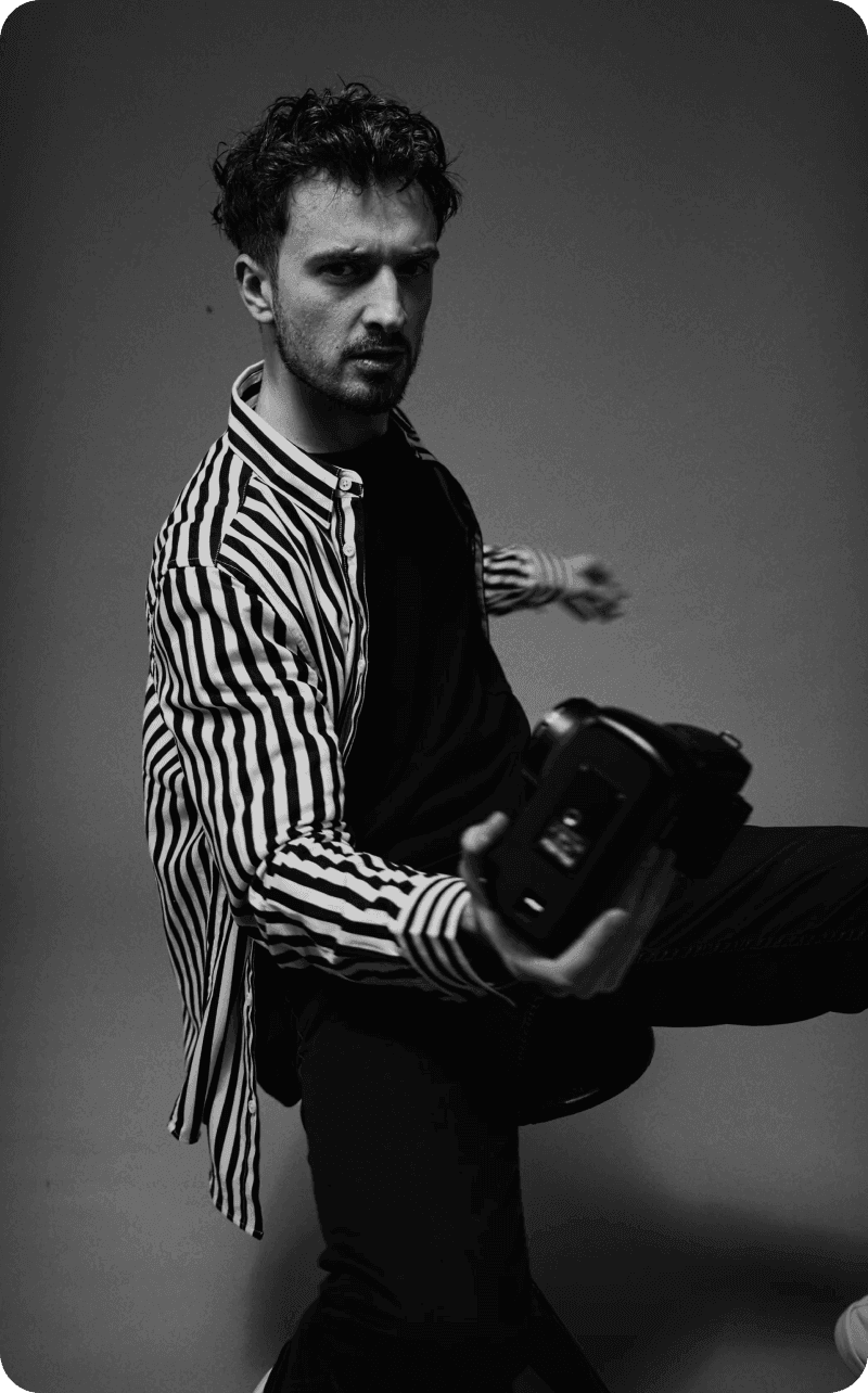 Black and white portrait of a man holding a camera